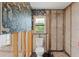 Bathroom with exposed beams, toilet, and a window with a view covered with floral wallpaper at 3226 Gardenia Dr, Hernando Beach, FL 34607