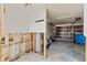 Spacious garage with concrete floors and a water heater partially framed with wood support beams at 3226 Gardenia Dr, Hernando Beach, FL 34607