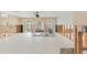 Spacious kitchen area featuring a large island, white tiled floors, and doorways leading to water views at 3226 Gardenia Dr, Hernando Beach, FL 34607