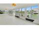 Bright sunroom features tile flooring and many windows providing beautiful waterfront views at 3226 Gardenia Dr, Hernando Beach, FL 34607
