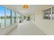 Inviting sunroom with tile flooring and wall-to-wall windows offering panoramic water views at 3226 Gardenia Dr, Hernando Beach, FL 34607