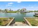 Waterfront view with steps leading to the water and a beautiful home with lush landscaping at 3226 Gardenia Dr, Hernando Beach, FL 34607