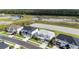 Aerial view of a neighborhood with homes and a green belt with walking trails and ponds at 33774 Castaway Loop, Wesley Chapel, FL 33543