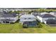 Aerial view showcasing the backyard with a screened-in pool and a spacious lawn at 33774 Castaway Loop, Wesley Chapel, FL 33543