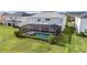 A view of the backyard with a screened-in pool and patio area at 33774 Castaway Loop, Wesley Chapel, FL 33543