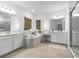Luxurious bathroom with double vanity, soaking tub, and glass-enclosed shower for a spa-like experience at 33774 Castaway Loop, Wesley Chapel, FL 33543
