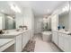Spacious bathroom featuring double sinks, lots of storage, a tub, and a glass enclosed shower at 33774 Castaway Loop, Wesley Chapel, FL 33543