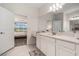 Bright bathroom offering neutral cabinets and countertops with a peek into the Primary bedroom at 33774 Castaway Loop, Wesley Chapel, FL 33543