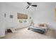 Cozy bedroom featuring neutral carpeting, a comfortable bed, and natural light from a large window at 33774 Castaway Loop, Wesley Chapel, FL 33543