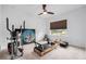 Bedroom with fitness equipment, neutral carpet, natural light, and a ceiling fan for a home gym setup at 33774 Castaway Loop, Wesley Chapel, FL 33543