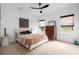 Well-lit bedroom with plush carpet, neutral decor, and ample natural light from dual windows at 33774 Castaway Loop, Wesley Chapel, FL 33543