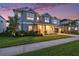 Beautiful two-story home featuring a cozy front porch and a freshly landscaped yard at 33774 Castaway Loop, Wesley Chapel, FL 33543