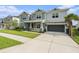 Beautiful two-story home featuring manicured lawn, two-car garage, and decorative stone accents on the porch columns at 33774 Castaway Loop, Wesley Chapel, FL 33543
