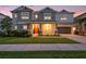 Charming two-story home with a welcoming porch and an attached two-car garage at 33774 Castaway Loop, Wesley Chapel, FL 33543
