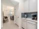 Hallway with modern cabinets, countertops, and access to the dining area at 33774 Castaway Loop, Wesley Chapel, FL 33543