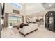 Open-concept living room with fireplace and sliding glass doors, seamlessly connecting indoor and outdoor spaces at 33774 Castaway Loop, Wesley Chapel, FL 33543