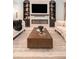 Cozy living room with a fireplace, modern decor, and a neutral color palette at 33774 Castaway Loop, Wesley Chapel, FL 33543