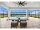 Relaxing outdoor space featuring a beautiful pool view and a dining table for entertaining at 33774 Castaway Loop, Wesley Chapel, FL 33543