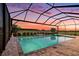 Gorgeous screened-in pool area offering stunning sunset views, perfect for relaxing at 33774 Castaway Loop, Wesley Chapel, FL 33543