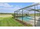 Relaxing pool area with a screened enclosure, beautifully landscaped surroundings, and a serene atmosphere at 33774 Castaway Loop, Wesley Chapel, FL 33543