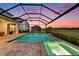 Inviting screened-in pool and spa area, perfect for enjoying the evening outdoors at 33774 Castaway Loop, Wesley Chapel, FL 33543