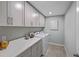Well-organized laundry room with ample cabinetry, countertop space, and modern washer and dryer at 3420 Timber Crossing Ave, Brandon, FL 33511