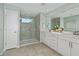 Bright bathroom featuring double sinks, tile flooring, and a glass enclosed shower at 3424 Timber Crossing Ave, Brandon, FL 33511