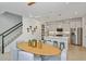 Open-concept kitchen with island seating and stainless steel appliances, flowing into dining area at 3424 Timber Crossing Ave, Brandon, FL 33511