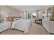 Comfortable main bedroom featuring a patterned accent wall, carpeted floors, and ample natural light at 3424 Timber Crossing Ave, Brandon, FL 33511