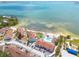 Stunning aerial view of bayfront community with beach, pool, and colorful buildings at 3595 41St S Ln # L, St Petersburg, FL 33711
