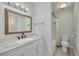 Bright bathroom featuring a vanity with marble countertop, framed mirror, and tub-shower combination at 3595 41St S Ln # L, St Petersburg, FL 33711