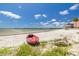 Serene beach scene with kayak, sandy shore, and views of the calm bay waters at 3595 41St S Ln # L, St Petersburg, FL 33711