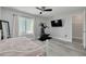 Bedroom with ceiling fan, TV, exercise machine, and a walk-in closet at 3595 41St S Ln # L, St Petersburg, FL 33711