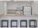 Kitchen with white cabinets, granite countertops, stainless steel appliances, and bar seating at 3595 41St S Ln # L, St Petersburg, FL 33711
