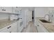 Modern kitchen featuring granite countertops, stainless steel appliances, and sleek white cabinetry at 3595 41St S Ln # L, St Petersburg, FL 33711