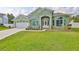 Inviting one-story home featuring a manicured lawn and attached two-car garage at 3634 Springville Dr, Valrico, FL 33596