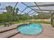 Charming pool and spa area within a screened enclosure, surrounded by lush greenery and outdoor seating at 3634 Springville Dr, Valrico, FL 33596