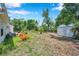 Backyard with landscaping, shed, and mature trees provide lots of shade at 3865 Gatewood Dr, Sarasota, FL 34232