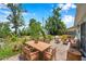 Lush backyard with brick patio and outdoor dining area perfect for entertaining at 3865 Gatewood Dr, Sarasota, FL 34232