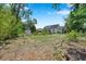 Spacious backyard featuring a shed, mature trees, and garden at 3865 Gatewood Dr, Sarasota, FL 34232
