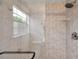 Tiled shower area with window showcasing upgraded shower head and fixtures at 3865 Gatewood Dr, Sarasota, FL 34232