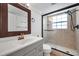 Bathroom featuring granite vanity, decorative framed mirror, and glass enclosed shower at 3865 Gatewood Dr, Sarasota, FL 34232