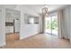 Bright dining area featuring sliding glass doors and wood-look floors at 3865 Gatewood Dr, Sarasota, FL 34232