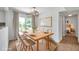 Stylish dining area with natural light, wood table, and neutral decor at 3865 Gatewood Dr, Sarasota, FL 34232