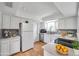 Bright kitchen with white cabinets, stainless steel appliances, and light countertops at 3865 Gatewood Dr, Sarasota, FL 34232