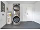 Functional laundry area with stacked washer and dryer and water heater at 3865 Gatewood Dr, Sarasota, FL 34232