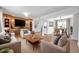 Bright and open living room featuring wood floors and built in shelving and adjacent dining and kitchen areas at 3865 Gatewood Dr, Sarasota, FL 34232
