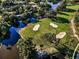 Beautiful aerial view of the golf course surrounded by water, sand traps, and lush greenery at 395 Forest Park Rd, Oldsmar, FL 34677