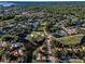 Community aerial showcases beautiful homes, lush green trees, lakes and a manicured golf course at 395 Forest Park Rd, Oldsmar, FL 34677