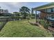 Waterfront backyard features a screened lanai, lush lawn, and a tranquil view at 395 Forest Park Rd, Oldsmar, FL 34677